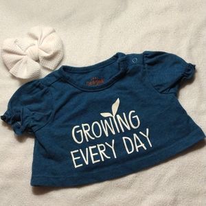 Growing every day shirt size 3-6 months with white bow.
